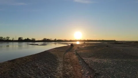 Epic drone shot of atv driving on a beach during sunset Stock Footage 334200065