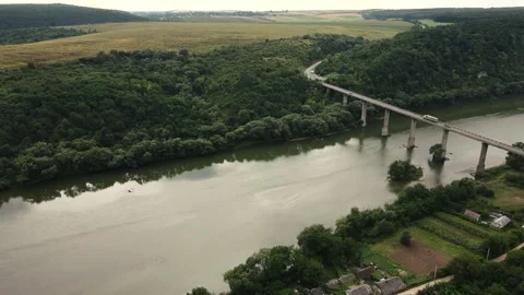 Epic drone shot of a bridge over the river with cars in the beautiful fields Stock Footage 208628487
