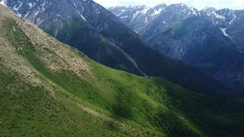 Epic drone shot of dramatic mountain peaks under a cloudy sky in Kazakhstan 스톡 동영상 337149214