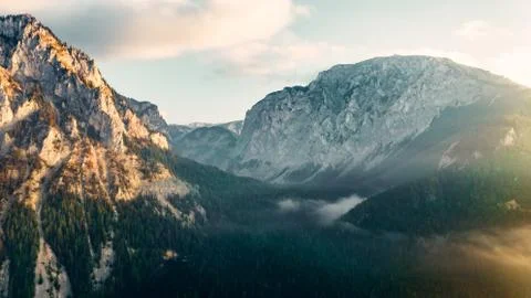 Epic drone shot over mountains at sunrise. Stock Photos