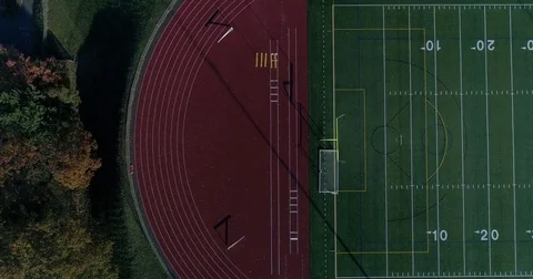 Epic drone shot pointing down at the football field aerial flying sideways Stock Footage 82326448