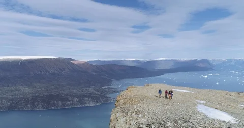 Epic Drone Shot Pulls Away From Hikers On An Epic Cliff Edge In Greenland Stock Footage 96042375