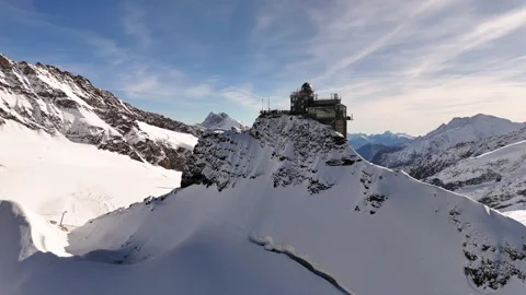 Epic drone shot of the Sphinx Observatory against the dramatic snowy landscape Stock Footage 296588767
