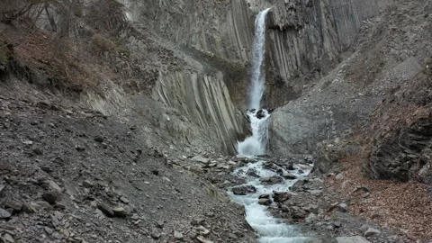 Epic Drone Shot of Waterfall Cascading Through Mountain Pass Video stock 303590149