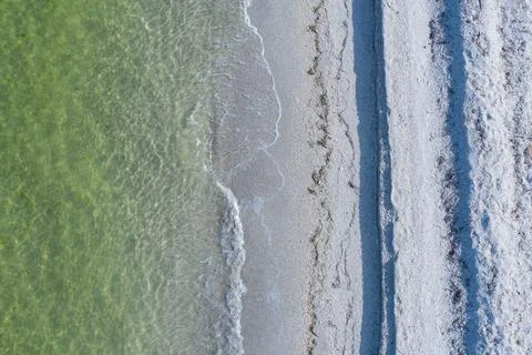 Epic drone shot of waves breaking on empty tropical beach Photos