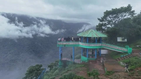 Epic drone view of tourists on a watchtower amid lush forest and swirling m.. Stock Footage 314206700