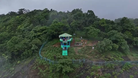 Epic drone view of tourists on a watchtower amid lush forest and swirling m.. Stock Footage 314206737