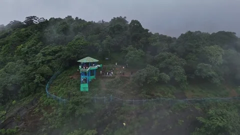 Epic drone view of tourists on a watchtower amid lush forest and swirling m.. Stock Footage 314206800
