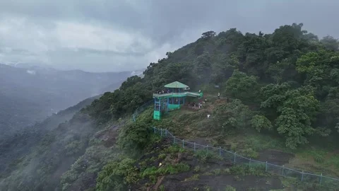 Epic drone view of a watchtower amidst jungle on a mountains edge, covered .. Stock Footage 314206721