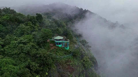 Epic drone view of a watchtower amidst jungle on a mountains edge, covered .. Stock Footage 314206754