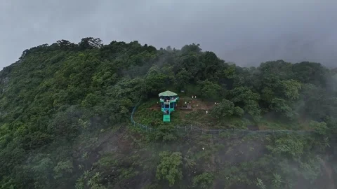 Epic drone view of a watchtower amidst jungle on a mountains edge, covered .. Stock Footage 314206758