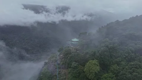 Epic drone view of a watchtower amidst jungle on a mountains edge, covered .. Stock Footage 314206776