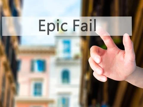 Epic Fail - Hand pressing a button on blurred background concept on visual sc Stock Photos