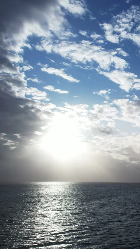 Epic flight over perfect deep blue sea with scenic white clouds in blue sky Stock Footage 283134396