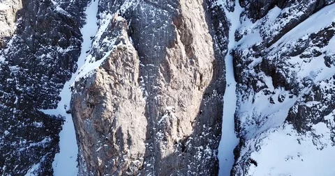 Epic fly on the drone rock covered with snow. Steep rocks among the snow. 스톡 동영상 100705265