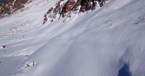 Epic fly on the drone rock covered with snow. Steep rocks among the snow. Video stock 100705818