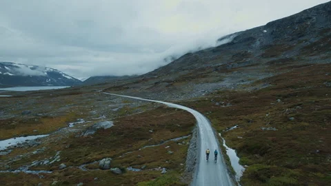 Epic flying drone shot of young cyclists riding Stock Footage 189450659