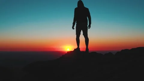 Epic Footage Of Man Silhouette At Dawn Sunrise Walking On Mountain Summit Pea Stock Footage