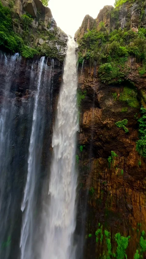 Epic FPV drone dive through stunning Tumpak Sewu waterfall in Indonesia Stock Footage 312435246