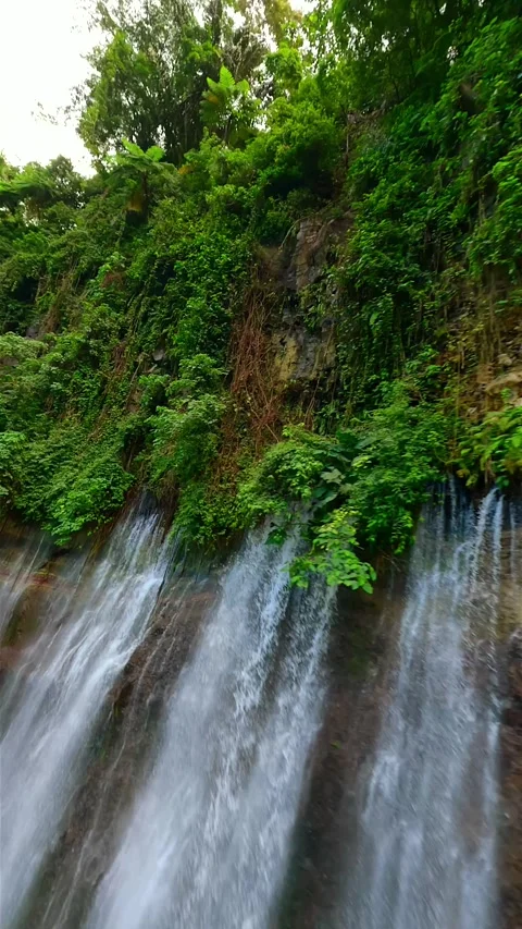 Epic FPV drone dive through stunning Tumpak Sewu waterfall in Indonesia Stock Footage 312435449