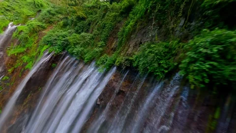 Epic FPV drone dive through stunning Tumpak Sewu waterfall in Indonesia Stock Footage 312436007