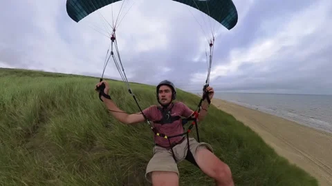 Epic frontal FPV view of man speed soaring with paraglider over coastal Stock-Footage 281072453