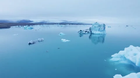 Epic Icebergs Floating in Calm Blue Waters Glacier Lagoon Aerial Flight Stock Footage 256717218