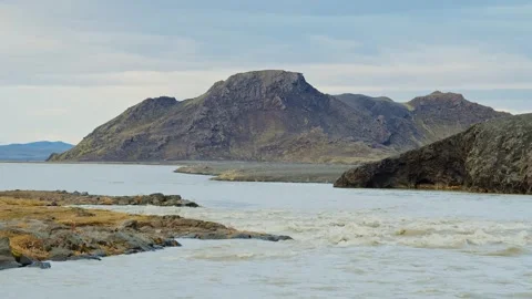 Epic Icelandic Landscape with Glacial River and Volcanic Mountains Stock Footage 320511403