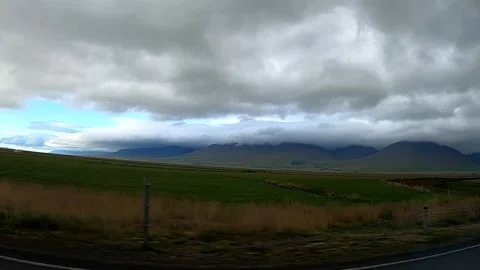 Epic low clouds over mountains seen from a moving car, Iceland Vídeos de archivo 333412353