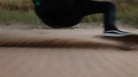 Epic low slomo view of paraglider coastal soaring dragging shoe over beach sand Stock Footage 324698210
