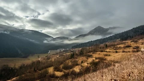 Epic misty clouds moving over snowy mountains in winter nature landscape Video stock 146045024