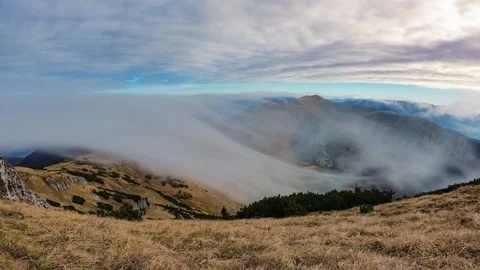 Epic misty clouds over alpine mountains in autumn nature landscape Time lapse Stock Footage 143082637
