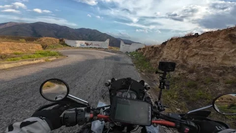 Epic Motorcycle POV Riding Through Winding Mountain Pass at Golden Hour 스톡 동영상 333921174