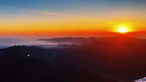 Epic Mountain Landscape with Vibrant Twilight Sky and Atmospheric Fog Stock Footage 320040832