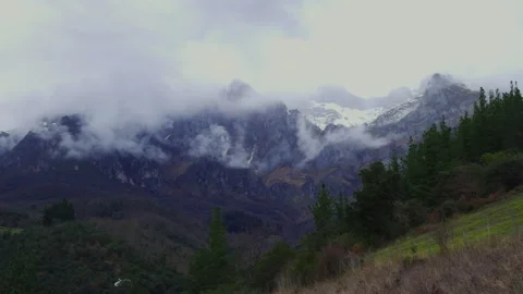 Epic mountain panorama with snow covered peaks and moving clouds Stock Footage 336622405