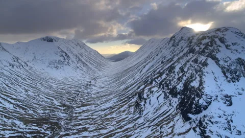 Epic mountain pass flight in winter at sunrise Video stock 336796586
