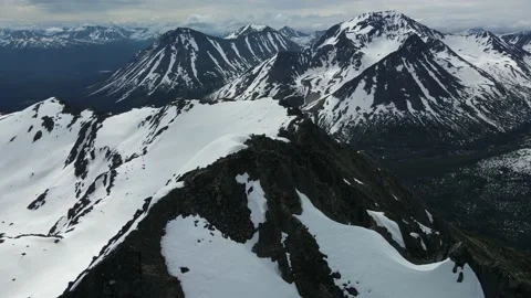 Epic Mountain Ridge Fly Over, Drone Shot, Spring Snow, Cloudy Day Stock Footage 169553845