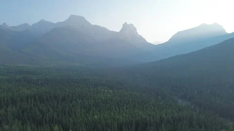 Epic Mountain Sunrise with Light Rays Over a Forest Stock Footage 318818020