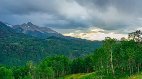 Epic Mountain Sunset with Aspen and Pine Forest, Brilliant Colored through to Stock Footage 128937778