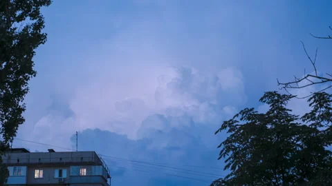 Epic movement of thunderclouds with lightning over the city in the evening. Video stock 205757528