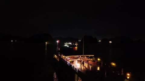 Epic night drone pull back revealing an illuminated luxury cruise ship 4K Stock Footage 340012270