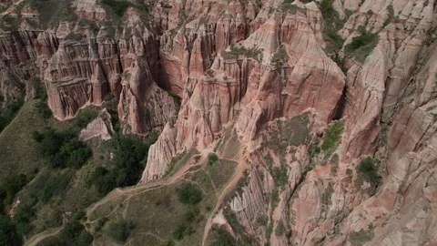 Epic Pullback tilt aerial shot of Rapa Rosie red canyon in Romania. Ascending Stock-Footage 309845692
