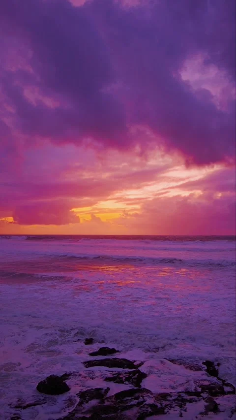 Epic Purple Sunset Over Ocean Waves and Rocky Shore Stock Footage 332039808