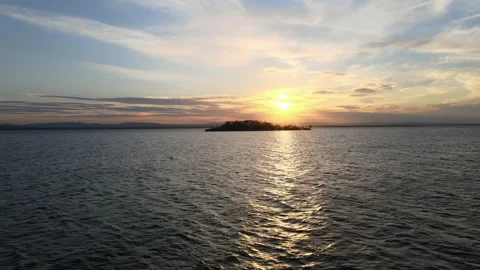 Epic push shot over sunset island on lake 動画素材 132237403