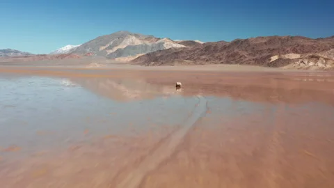 Epic rapid flying back from stone with race track on the wet surface of desert 스톡 동영상 137351873