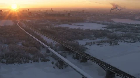Epic Red sunset of industrial snow covered big city. Aerial cityscape drone view Stock Footage 102329780
