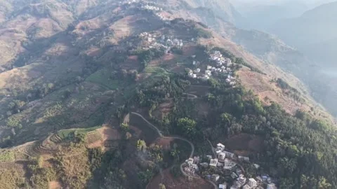 Epic Reveal Aerial Pull-back From a Mountain Ridge Village to Vast Chinese M Stock Footage 328334734