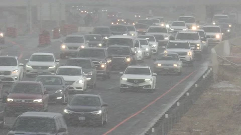Epic rush hour traffic jam on highway as snow starts to fall 動画素材 149546012