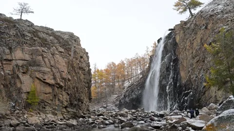 Epic Scale: Tiny People at a Massive Waterfall in a Remote Mongolian Canyon Stock Footage 318605914