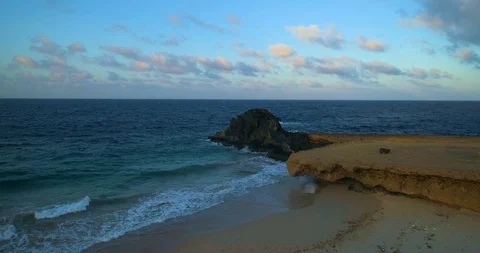 A epic scenery fly out of big rocks in the sea to shore Stock-Footage 97768126